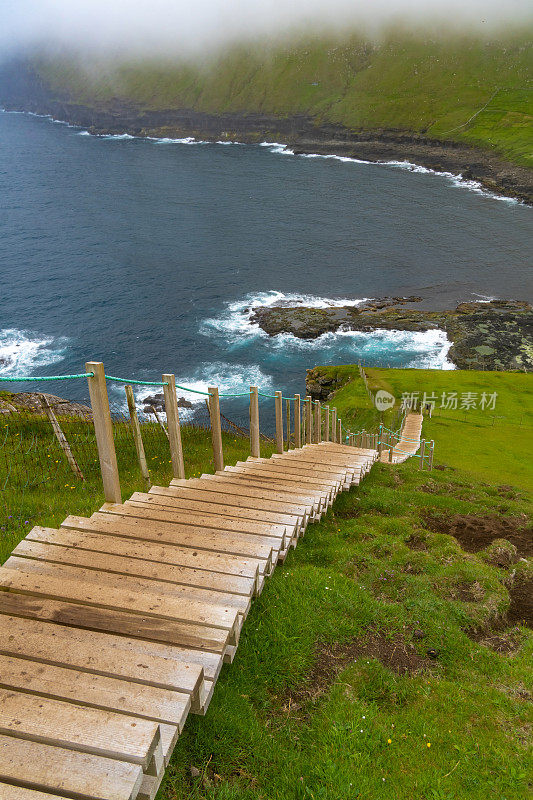 在GjÃ³gv (gorge, geo)， Eysturoy岛，法罗群岛的悬崖徒步旅行开始时有陡峭的楼梯。